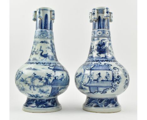 A pair of Ming or blue and white ceramic five-tube figurine vases. Each baluster shaped vase decorated with fret and lappets 