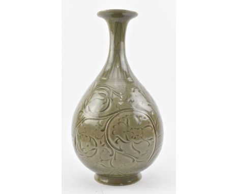 A Yaozhou kiln yuhuchun ceramic vase. The pear-shaped body rising from an everted foot to a flared rim, carved with flowers.M