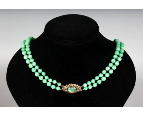 A CHINESE LATE 18TH-EARLY 19TH CENTURY DOUBLE ROW OF GRADUATED JADE BEADS, set with an emerald and diamond clasp.