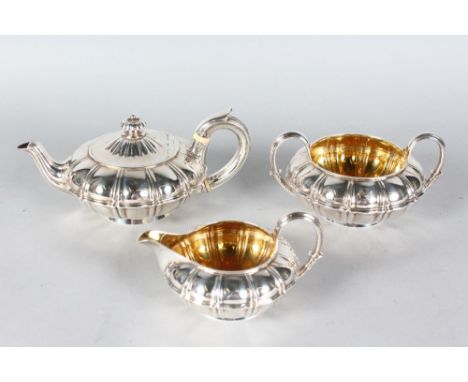 A WILLIAM IV CIRCULAR MELON SHAPED TEAPOT, SUGAR BASIN AND MILK JUG. London 1830.  Makers: Garrards.  Weight 38ozs.