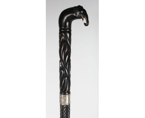 A CEYLONESE SILVER MOUNTED EBONY WALKING STICK.