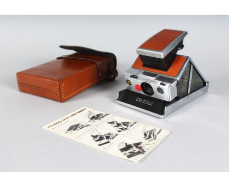 A FOLDING POLAROID CAMERA in a leather case.
