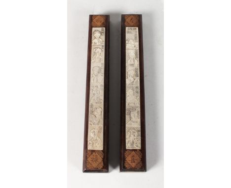 A PAIR OF CHINESE ROSEWOOD AND METAL SCROLL WEIGHTS, each depicting women, possibly of the court. Each 12ins long.