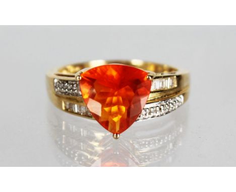 A 14CT YELLOW GOLD TRILLION CUT FIRE OPAL with diamond shoulders.