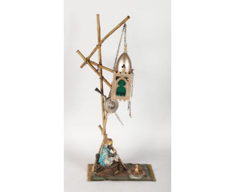 A SUPERB BERGMAN LAMP, AN ARAB MAN SITTING ON A CHAIR BENEATH A LAMP, all on a Persian rug. Signed.  19ins  high.
