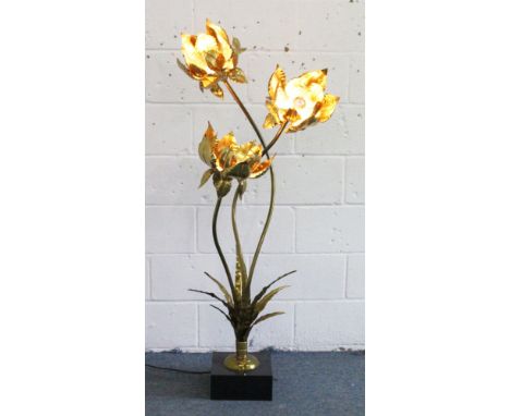 AN UNUSUAL ARTS & CRAFTS GILDED METAL THREE LIGHT LAMP formed as three scrolling flower heads. 5ft high.