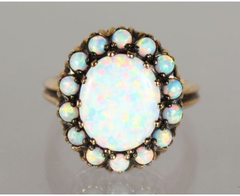 A 9CT GOLD OVAL OPAL DRESS RING.