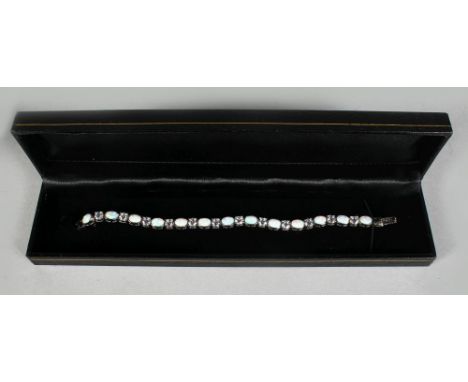 A SILVER AND GILSON OPAL TENNIS BRACELET.