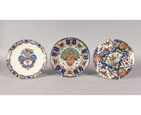 THREE POLYCHROME DUTCH DELFT PLATES, MID-LATE 18TH CENTURY, boldly painted in blues, iron-reds, ochre and green with floral m