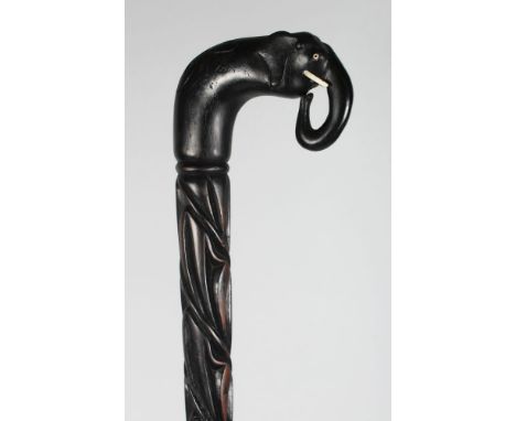 A CEYLONESE SILVER MOUNTED EBONY WALKING STICK.