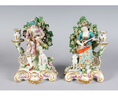 A SUPERB PAIR OF SAMSON "CHELSEA DERBY" SEATED BAGPIPER AND LADY CANDLESTICK GROUPS, the man with a dog by his side and the l