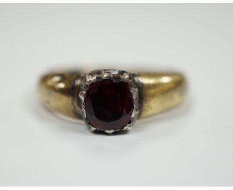 A yellow metal and collet set solitaire ruby ring, size M, gross weight 3.2 grams.