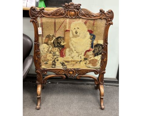 A Victorian carved walnut firescreen, worked with a scene after Landseer, width 84cm, height 113cmProvenance: Same owner sinc