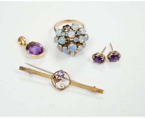 A cased 9ct, three stone amethyst and ruby set bar brooch, 49mm, a 14k and opal cluster set dress ring, a yellow metal and am