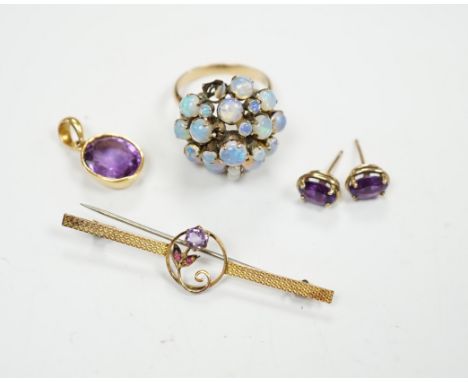 A cased 9ct, three stone amethyst and ruby set bar brooch, 49mm, a 14k and opal cluster set dress ring, a yellow metal and am