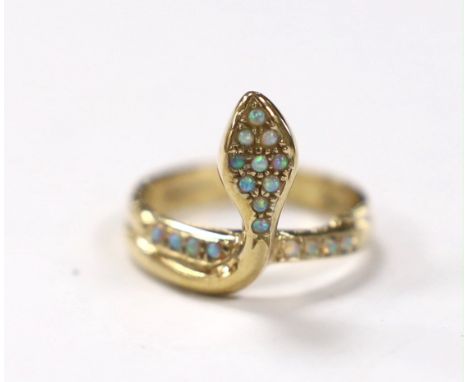 A modern 9ct gold and white opal cluster set serpent ring, size M, gross weight 3.7 grams.