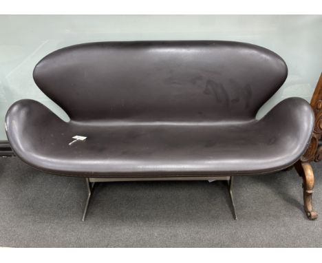 In the manner of Arne Jacobsen, a dark brown leather and chrome Swan sofa, width 142cm, depth 62cm, height 78cm Several small