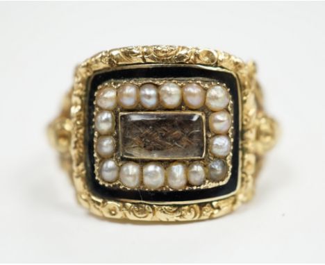 A George IV 18ct gold, black enamel and seed pearl set mourning ring, with plaited hair beneath a glazed panel, size Q, gross