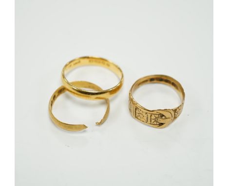 Two 22ct gold wedding bands (one cut), 5.8 grams and an 18ct gold buckle ring, 2.9 grams.