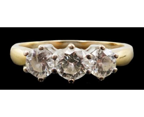 A modern 18ct gold and three stone diamond set ring, the three round brilliant cut stones with a combined weight of 1.00ct, s