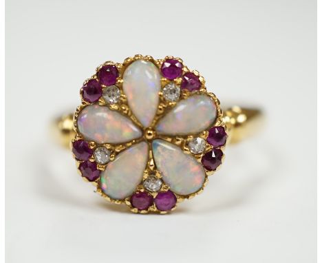 An Edwardian 18ct gold, white opal, ruby and diamond cluster set ring, size K, gross weight 3.1 grams.