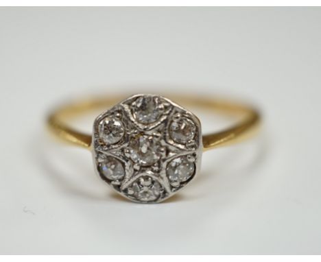 A 1920's 18ct, plat and seven stone diamond set cluster ring, size K, gross weight 2.2 grams.