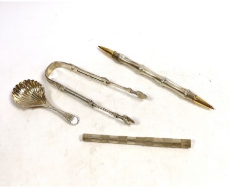 A George III silver bright cut engraved caddy spoon, Walter Brind, London 1785, 91mm, a pair of Georgian silver sugar tongs a