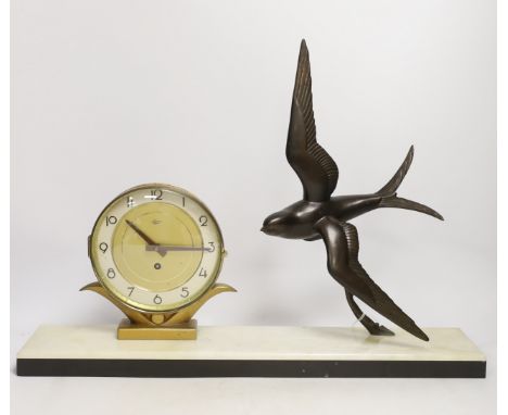 A French Art Deco 'swallow' mantel clock, 54.5cm The swallow is pitted - created in manufacture, the maroon enamel at the bac