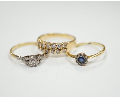 Three assorted yellow metal and gem set rings including an 18ct, plat and illusion set solitaire diamond ring, size Q, gross 