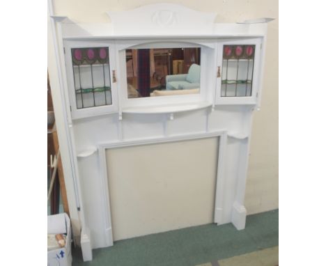 An Arts &amp; Crafts white painted fireplace surround in the manner of the Glasgow designer E. A. Taylor, with a deep moulded