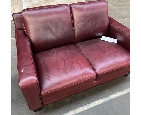 A Contemporary red/ burgundy leather two seat sofa 