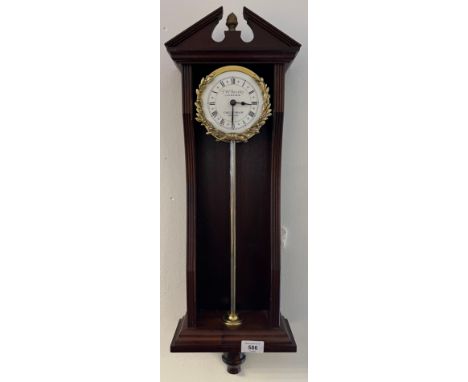 T.W. Bazeley Clockmaker Cheltenham England rise and fall wall clock. Mahogany casing, Gilt brass barrel clock, enamel face wi