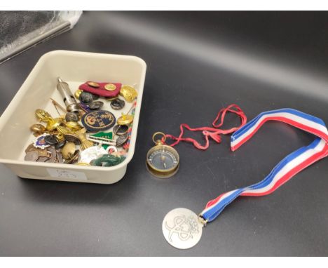 A Tray of military and other badges, includes 1954 military whistle, RTYC Gold thread patch, WW2 medal and various coins whic