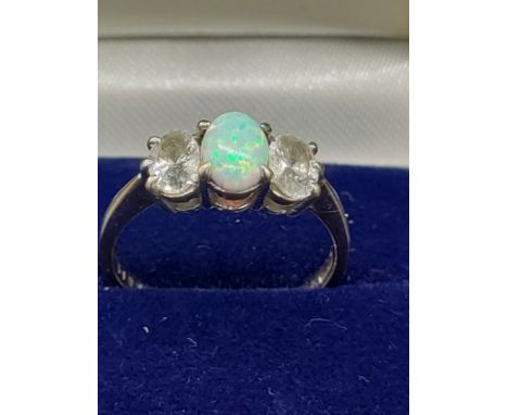 9ct yellow gold ladies ring with a single opal stone off set by CZ Stones. [Ring size O] [2.55Grams] 