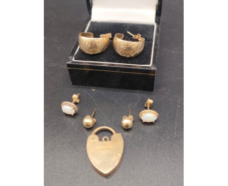 A Selection of 9ct gold earrings and 9ct gold heart shaped locket. Includes a pair of 9ct and opal earrings. [5.80grams] 