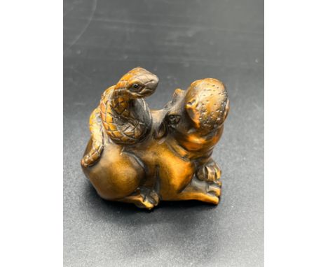Japanese hand carved box wood netsuke sculpture of a Hippo resting with a snake upon its back. Both fitted with black bead ey