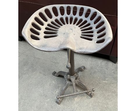 A Cast metal bar stool, tractor seat area. 