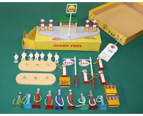 A quantity of Dinky Toys. Petrol Pump Station 'Shell' (782). A 'Pratts' Oil Bin (49e) together with 4 early Petrol Pumps. 2x 