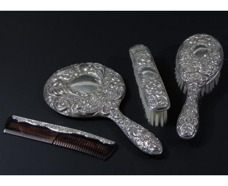 A four piece silver back dressing table set, comprising of a hand mirror 24cm high, hairbrush, clothes brush and comb, each w