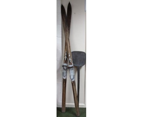 Rural bygones, a pair of vintage skis with metal mounts, and a stained wooden malt shovel, 133cm high. (a quantity)