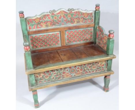 A Chinese hardwood garden seat, of good proportion with polychrome scroll and floral back, the slatted seat flanked by carved