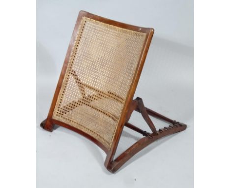 An early 20thC stained mahogany and bergere bed rest, with adjustable back and shaped turned supports, 57cm wide.