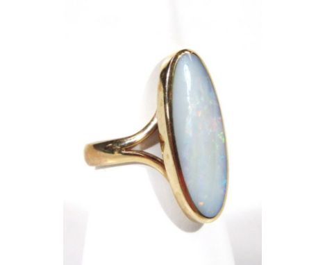 An opal style dress ring, the oval stone on part pierced shank, marked 375, size M, 5.5g all in.