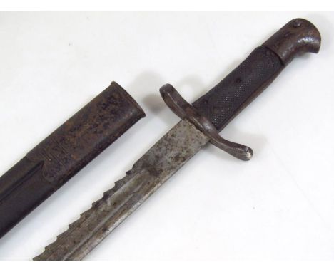 A British saw back bayonet, model 1879 with part metal scabbard and metal ended textured hilt, 57cm wide.