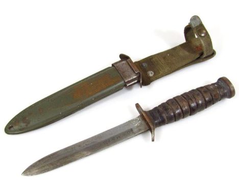 An American USM8 BMCO bayonet knife, with metal scabbard and material fitting, 32cm high.