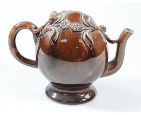 A Cadogan teapot, in the manner of Brameld with shaped acorn and leaf top, moulded handle and spout and oval foot, 16cm high.