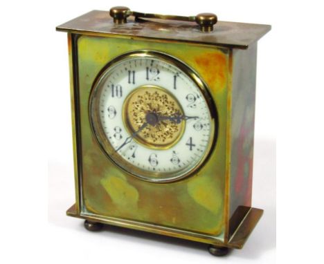 An early 20thC brass cased mantel clock, with 8cm dia. dial with Arabic numerals revealing a keywind movement, in a polished 