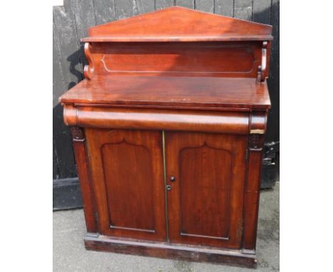 A Victorian mahogany chiffonier, with fixed cornice raised above cushion drawer and double cupboard on block base, the upper 