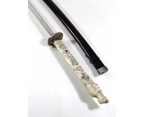 A reproduction Japanese Samurai sword, with curved stainless steel blade and heavily cast resin handle, with shaped circular 