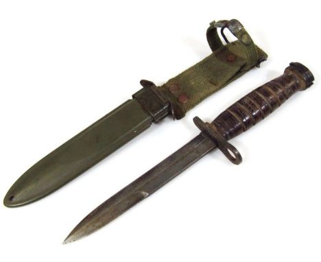 An American USM8 BMCO bayonet knife, with metal scabbard and material fitting, 32cm high.